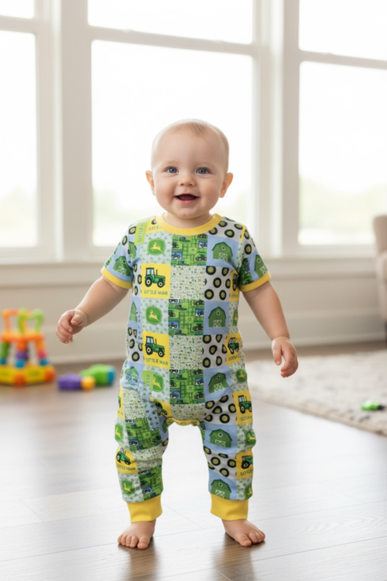 Little man" Tractor printed boys baby romper w/yellow trim.